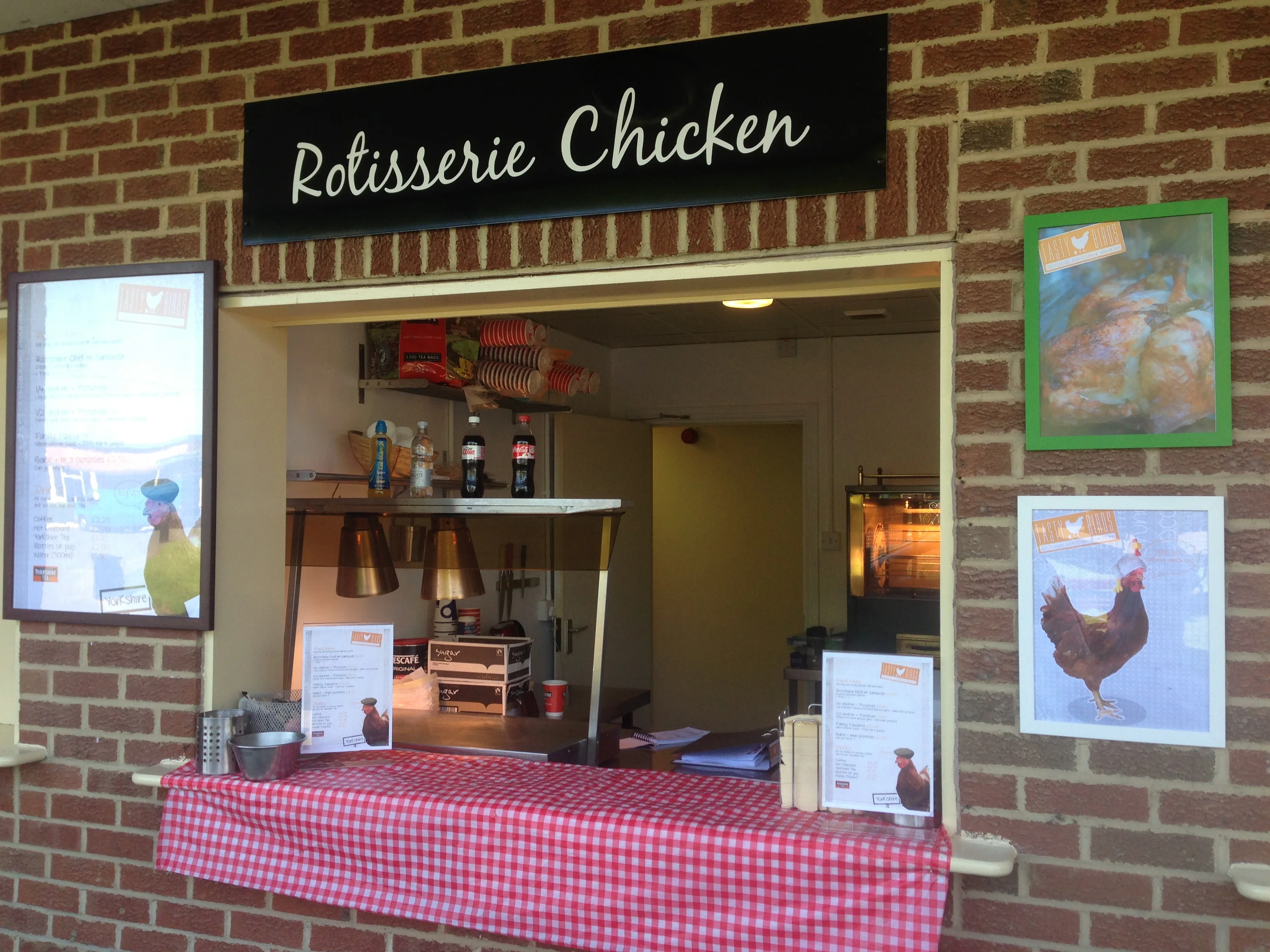 Tastybirds rotisserie chicken counter with Rotisserie Chicken sign